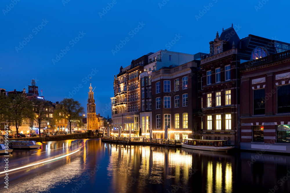 Night city view of Amsterdam, the Netherlands with Amstel river.
