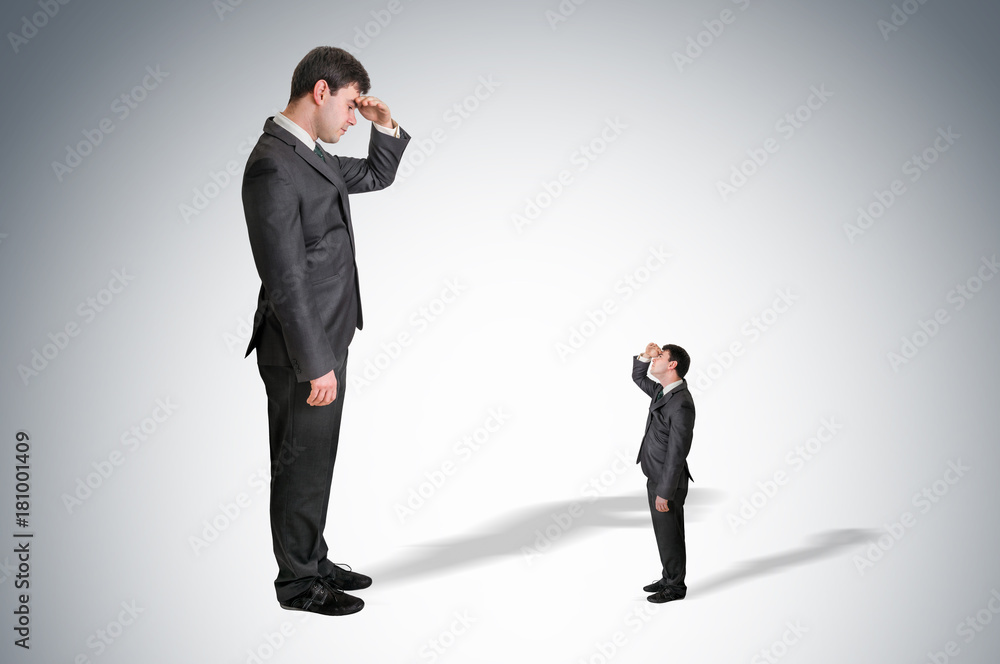 Big businessman and small businessman watch each other Big businessman and small businessman watch each other