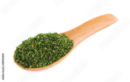 dried parsley in spoon isolated on white background