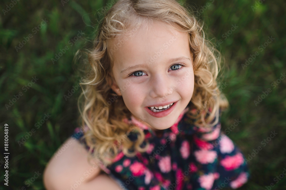 Overhead portrait of blond haired girl on grass Overhead portrait of blond haired girl on grass