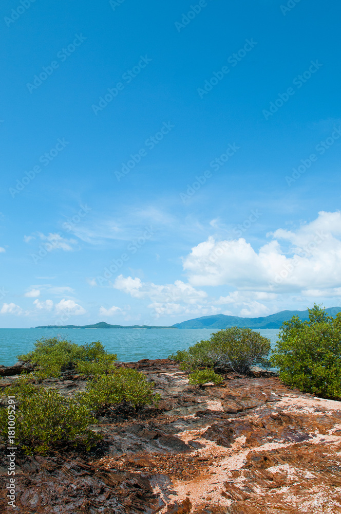 Rock sand beach with green bushes on small island near Koh Lanta