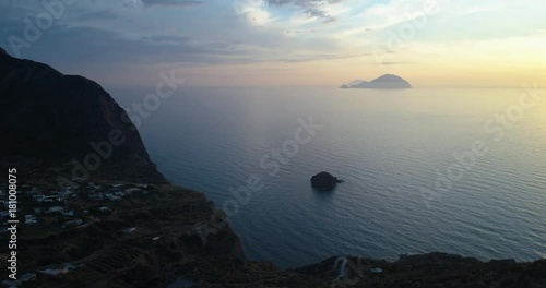 discovering aerial view of mediterranean sea ocean town pollara at sunset or sunrise.Nature outdoors travel establisher,Italy,Sicily Eolian Salina Island.Summer or spring.4k drone establishing video photo