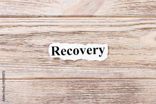 Recovery of the word on paper. concept. Words of Recovery on a wooden background photo