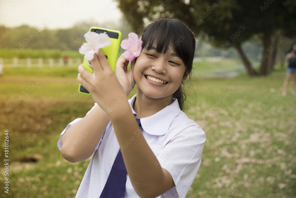Attractive young Asia woman taking selfie in the garden. Attractive young Asia woman taking selfie in the garden.
