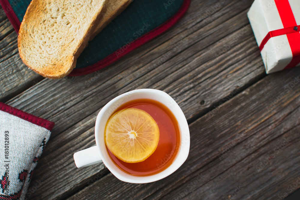 On wooden background, on the boards of toasted bread with tea and cakes On wooden background, on the boards of toasted bread with tea and cakes