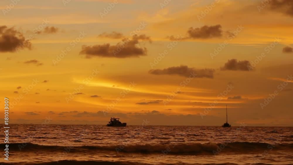 Gorgeous sunset on Naiharn beach. Cloudscape on orange sunset background. Gorgeous sunset on Naiharn beach. Cloudscape on orange sunset background.