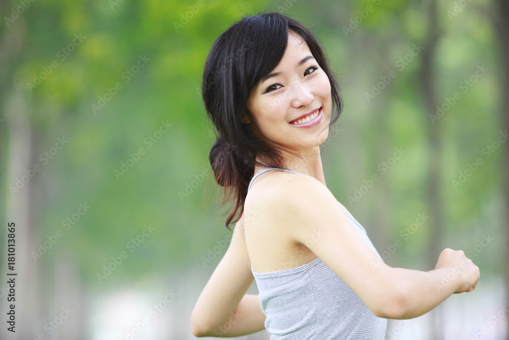 one pretty young asian woman doing morning exercise in the park one pretty young asian woman doing morning exercise in the park