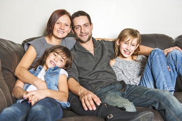 Portrait of family having fun in the living room. Happy family spending time at home together.