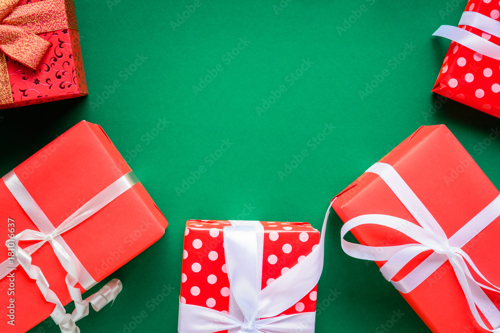 Fototapeta premium christmas and gift boxes on the green table