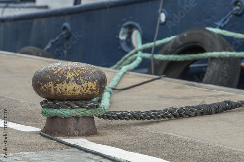 Bollard at the pier for mooring with an anchor line.