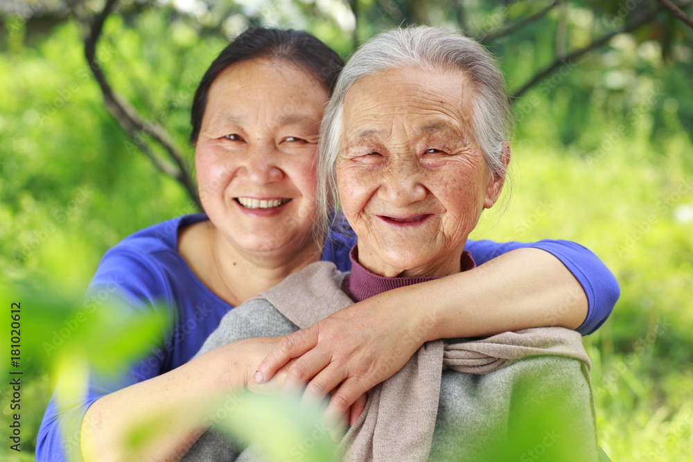 Senior asian woman with her daughter in the yard