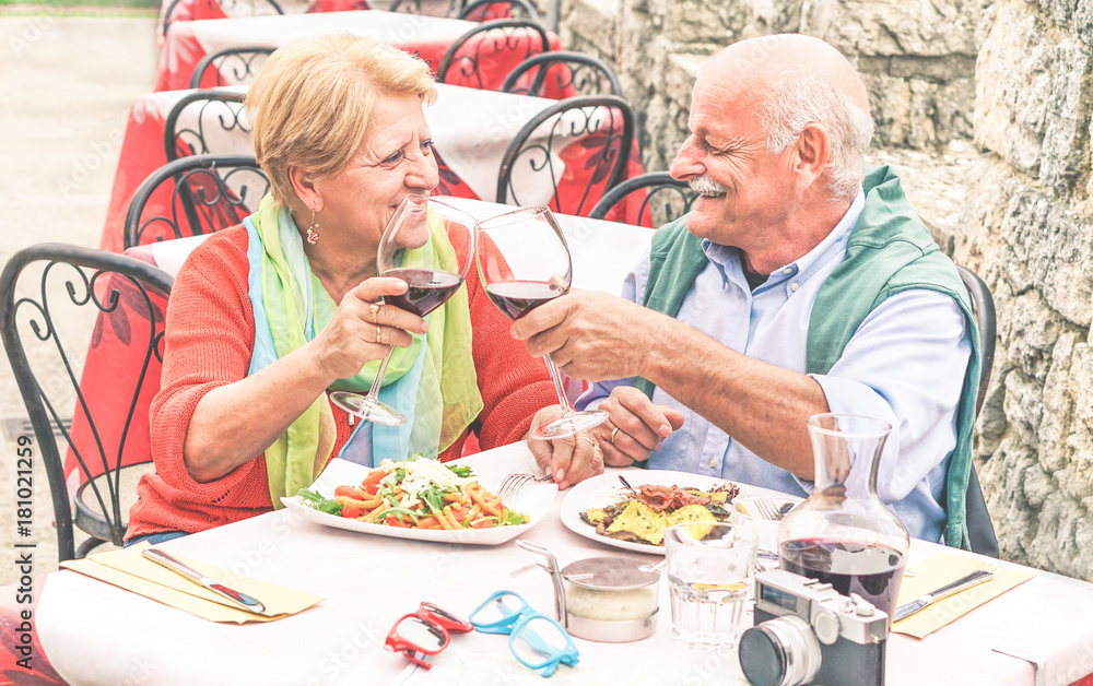 Retirement senior couple drinking and eating in restaurant outdoor - Mature Husband and wife having fun in romantic vacation- Love and joyful elderly lifestyle concept - Warm contrast filter Retirement senior couple drinking and eating in restaurant outdoor - Mature Husband and wife having fun in romantic vacation- Love and joyful elderly lifestyle concept - Warm contrast filter