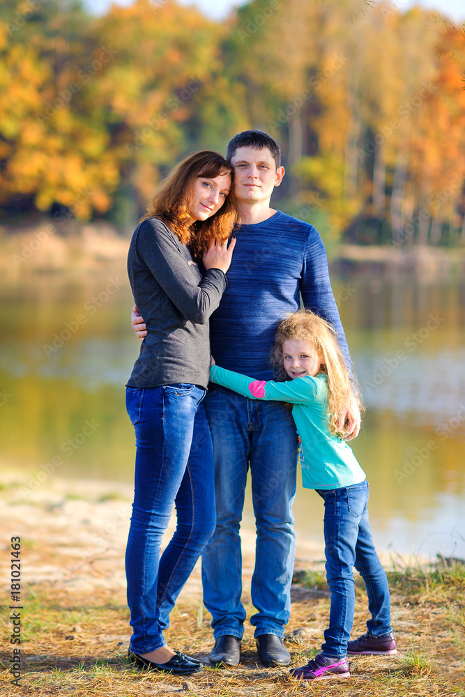 Fototapeta premium happy family resting outdoors, amicably hugging and smiling