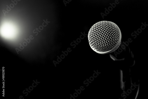 Retro Microphones on front stage in pub bar or restaurant. Classic sing a song in evening and night show on black light background.