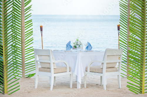 Romantic wedding dinner setting outdoor on the beach. © sakarin14