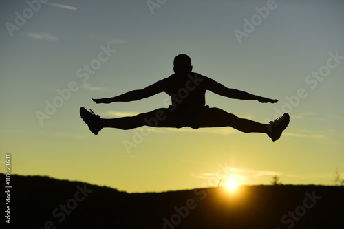 Wallpaper Mural Silhouette of athlete jumping on sunset background, copy space. Torontodigital.ca