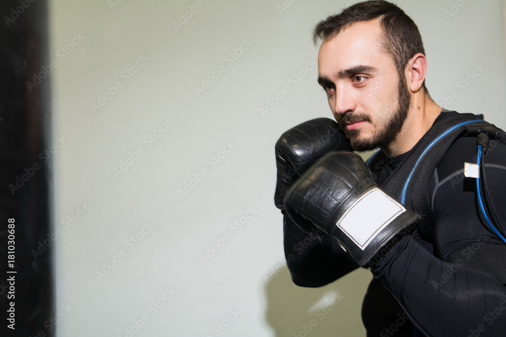 Man in boxing gloves in the rack. Man in boxing gloves in the rack.