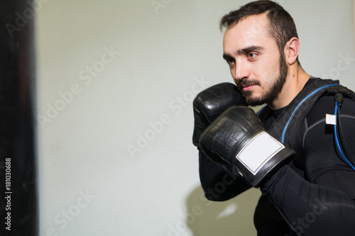 Man in boxing gloves in the rack. © kanzefar