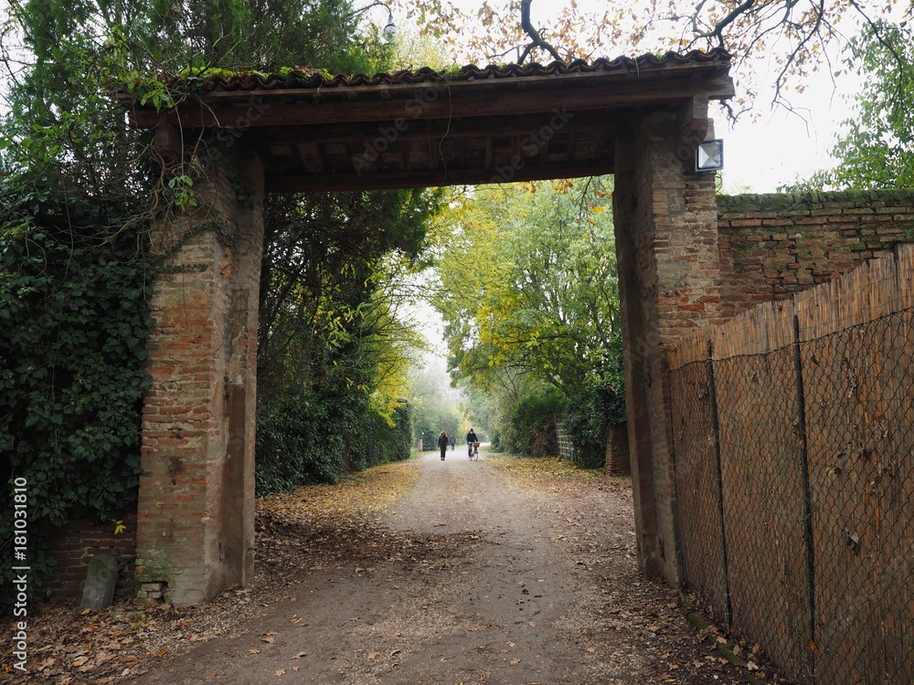  Country road with large brick portal.
