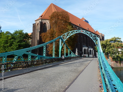 Tumski bridge and Church of Our Lady on Sand in Wroclaw. Poland. Padlock on the bridge.