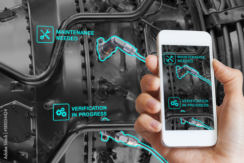 Augmented Reality technology maintenance, technician using smartphone, AR interface, monitoring photo