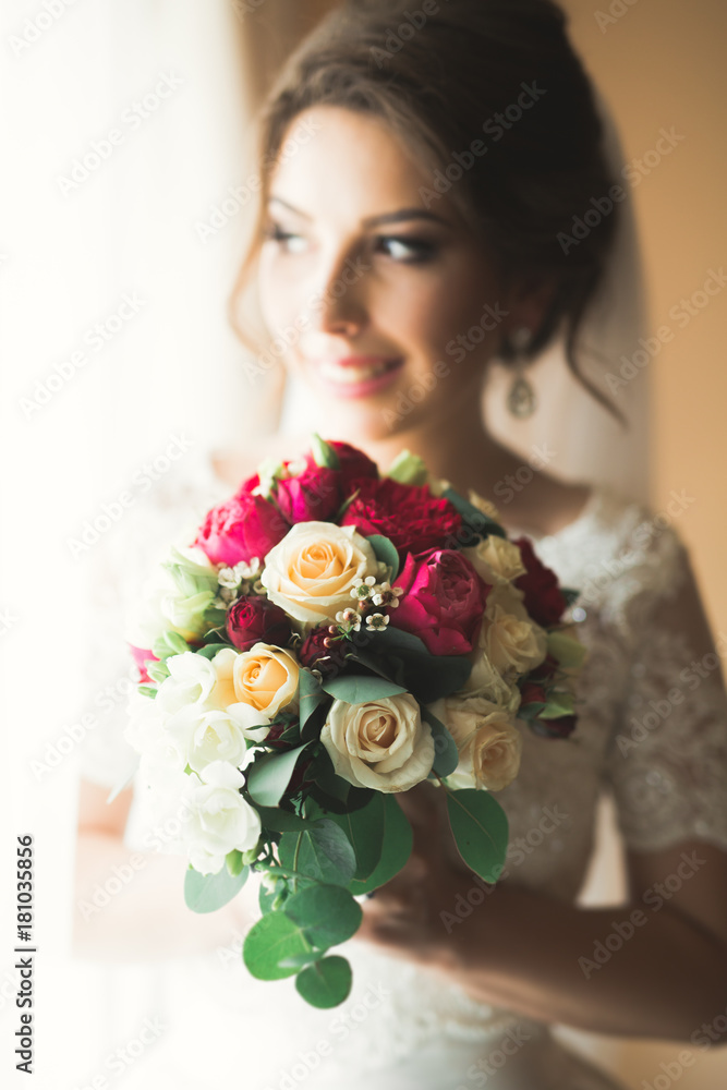 Luxury bride in white dress posing while preparing for the wedding ceremony Luxury bride in white dress posing while preparing for the wedding ceremony