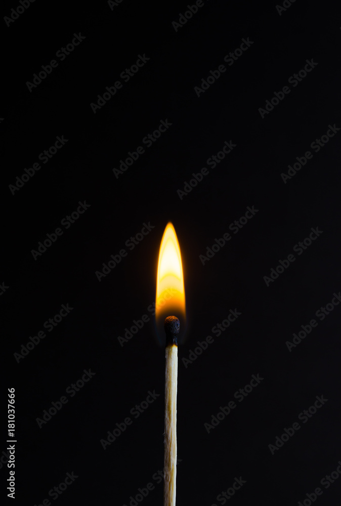 Photo of a burning match on a black background Photo of a burning match on a black background