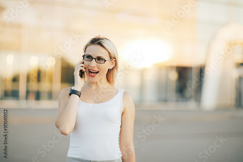 Business woman talking on the phone, standing in the street