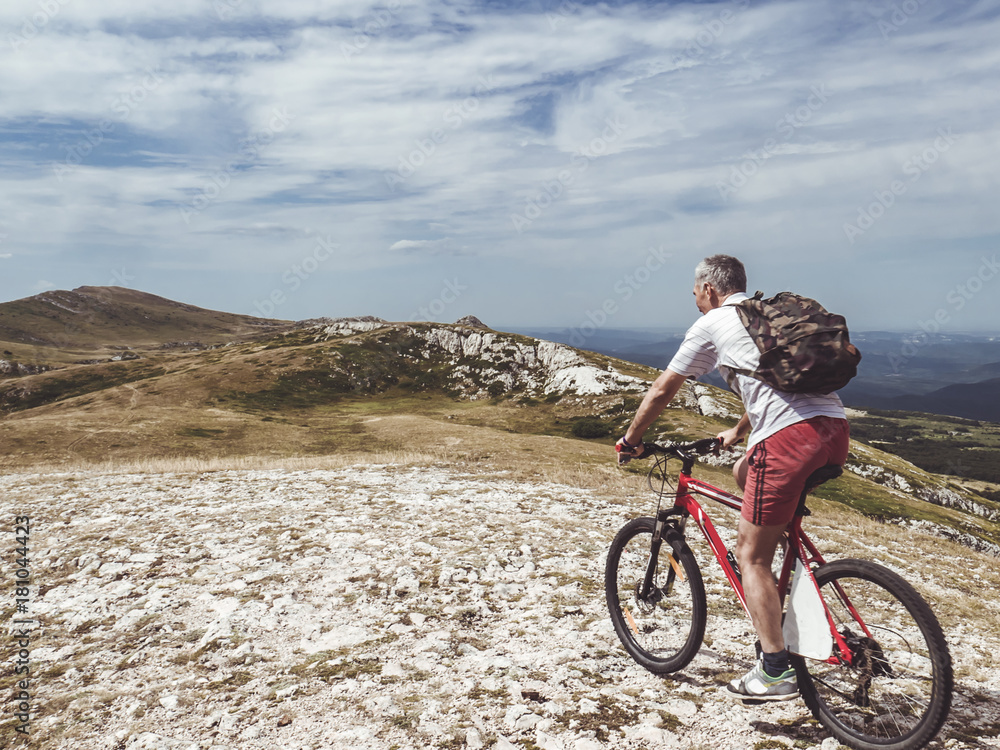 Fototapeta premium man riding the bike in the mountains