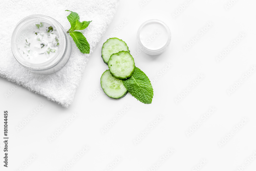 Cucumber moisturising cream or mask. White background top view copyspace Cucumber moisturising cream or mask. White background top view copyspace