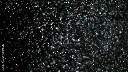 Snowfall Bokeh Lights on Black Background, Shot of Flying Snowflakes in the Air © mputsylo