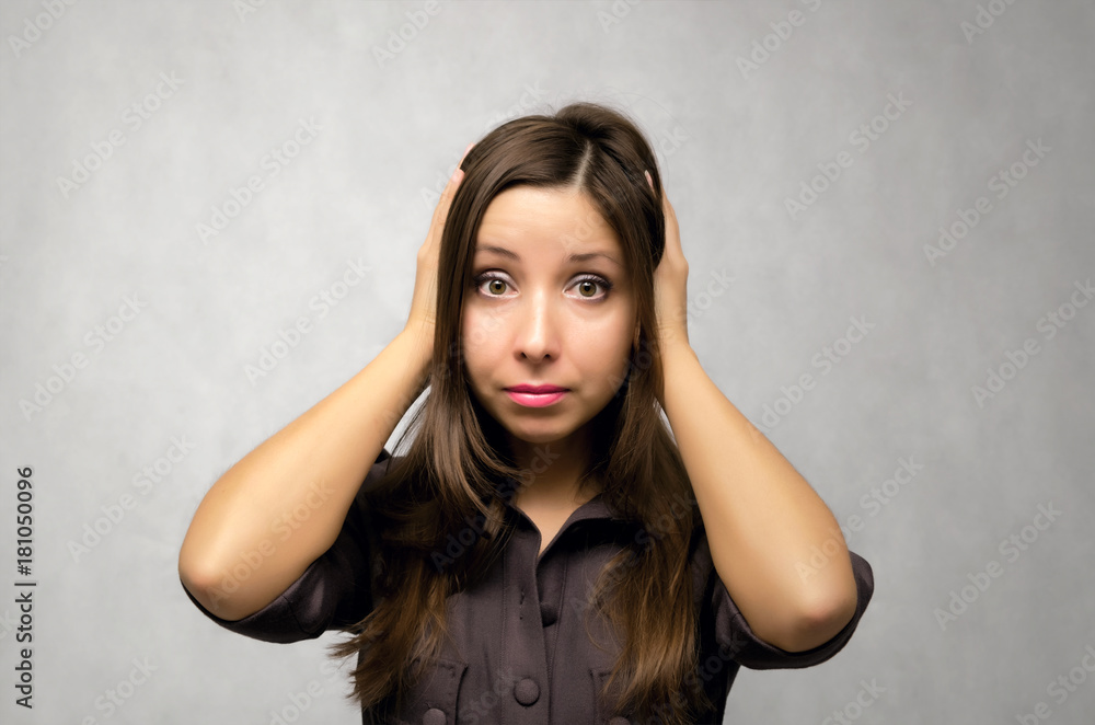 Young caucasian woman in dress covers her ears with her hands. Hear no evil. Girl in stress. Girl holds her hands with her head isolated. Young caucasian woman in dress covers her ears with her hands. Hear no evil. Girl in stress. Girl holds her hands with her head isolated.