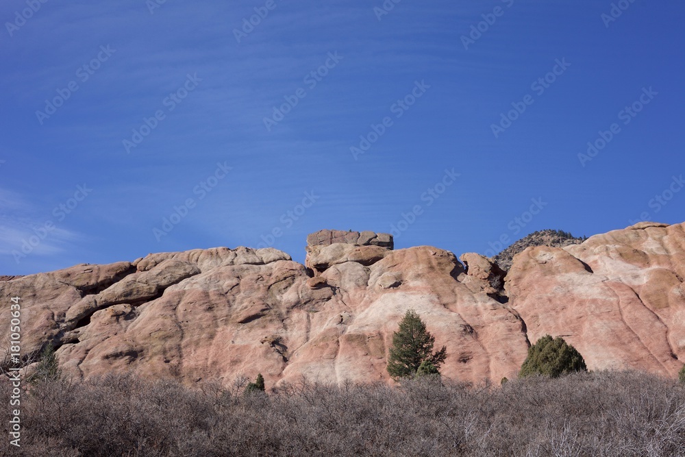 Fototapeta premium Red Rocks reaching to the sky on a sunny blue sky day