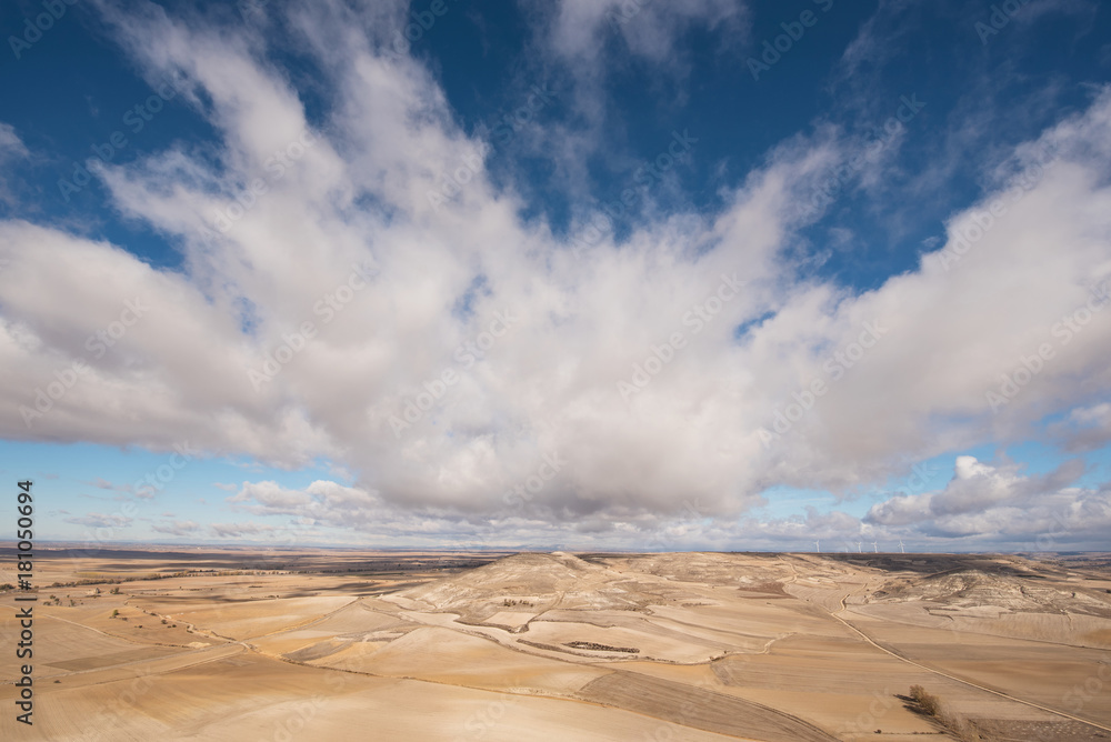 Countryside landscape in Burgos province, Castilla y Leon, Spain. Blue sky and clouds sky over the agricultural fields. Countryside landscape in Burgos province, Castilla y Leon, Spain. Blue sky and clouds sky over the agricultural fields.