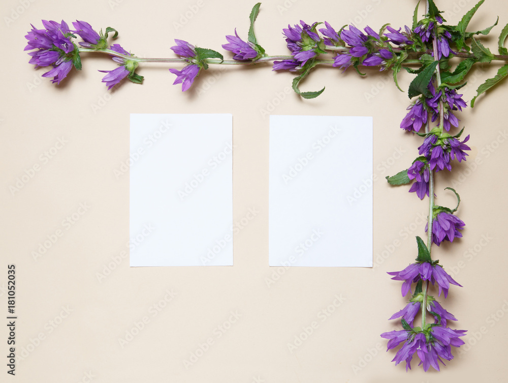 Flower frame made of bells on a beige background.