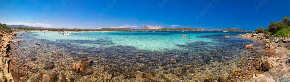 Cala Brandinchi beach with Isola Travolara in the background, red stones and azure clear water, Sardinia, Italy Cala Brandinchi beach with Isola Travolara in the background, red stones and azure clear water, Sardinia, Italy