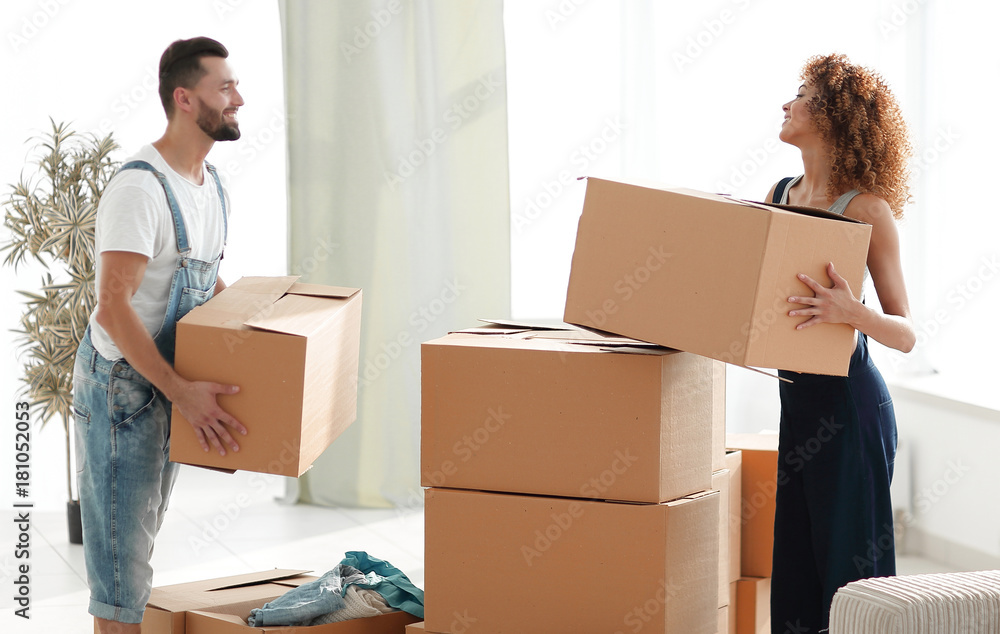 Young family unpacking boxes in a new house. Young family unpacking boxes in a new house.
