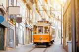 Street view with famous retro tourist tram in the old town of Porto city, Portugal