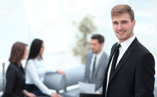 portrait of confident businessman on background of office.
