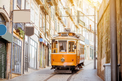 Fototapeta Street view with famous retro tourist tram in the old town of Porto city, Portug