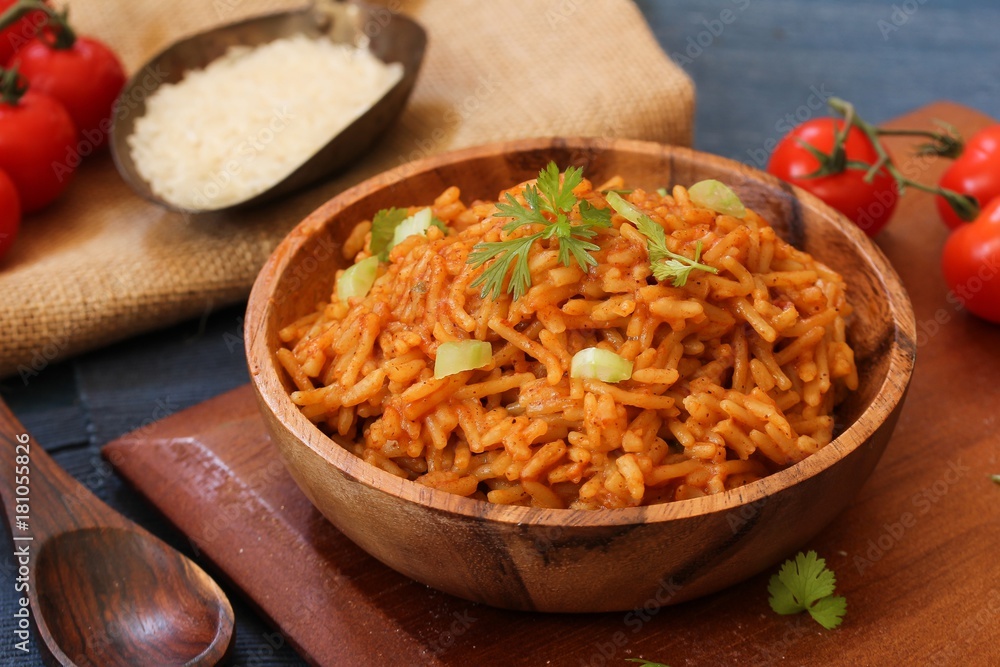 Home cooked Spanish rice served in a wooden bowl, selective focus