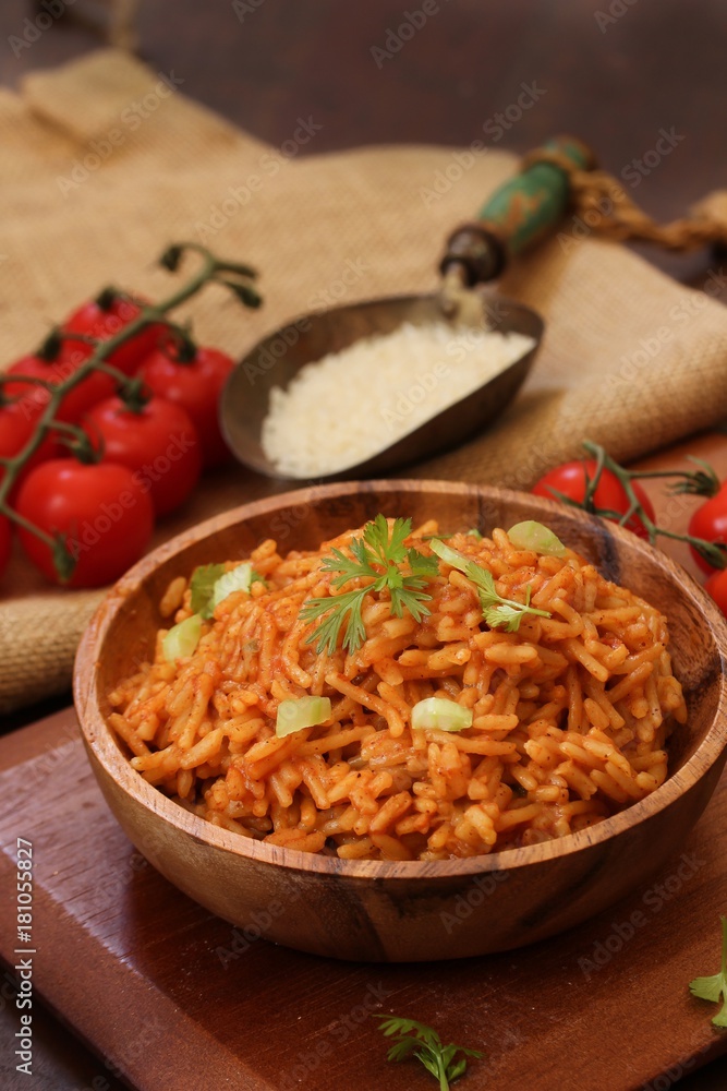 Home cooked Spanish rice served in a wooden bowl, selective focus Home cooked Spanish rice served in a wooden bowl, selective focus