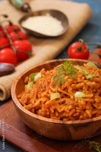 Home cooked Spanish rice served in a wooden bowl, selective focus