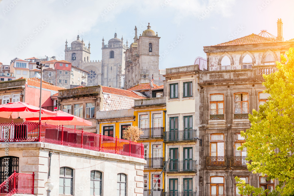 View on the beautiful old building facades on the street with Se cathedral in the old town of Porto city, Portugal