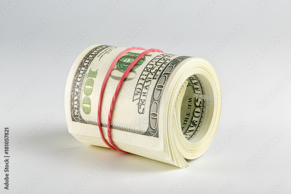 The pack of dollars is twisted into a roll The pack of dollars is twisted into a roll