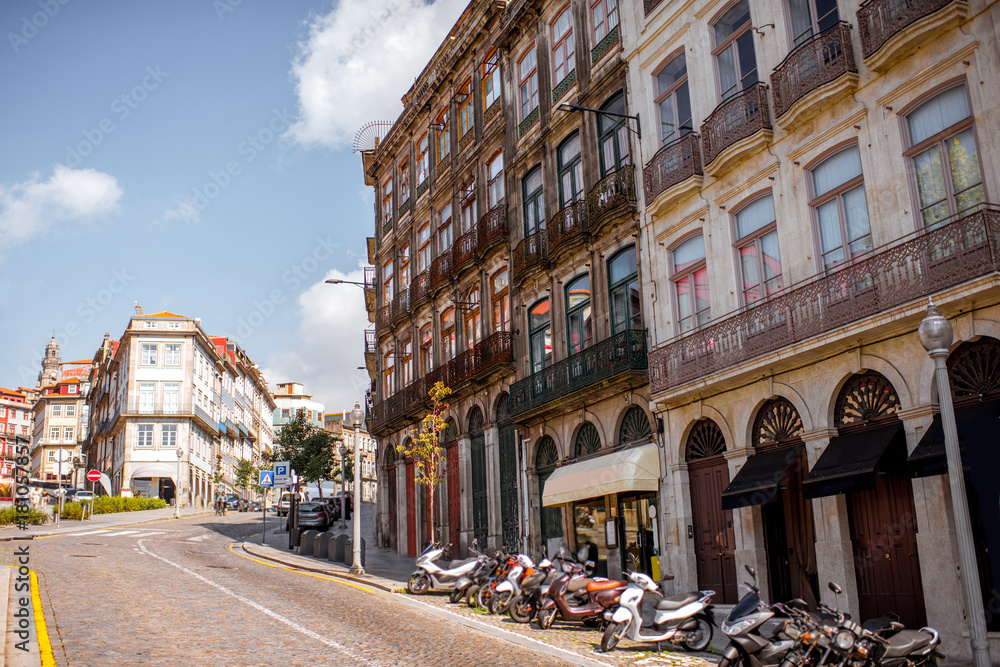 Street view on the beautiful old buildings with portuguese tiles on the facades in Porto city, Portugal