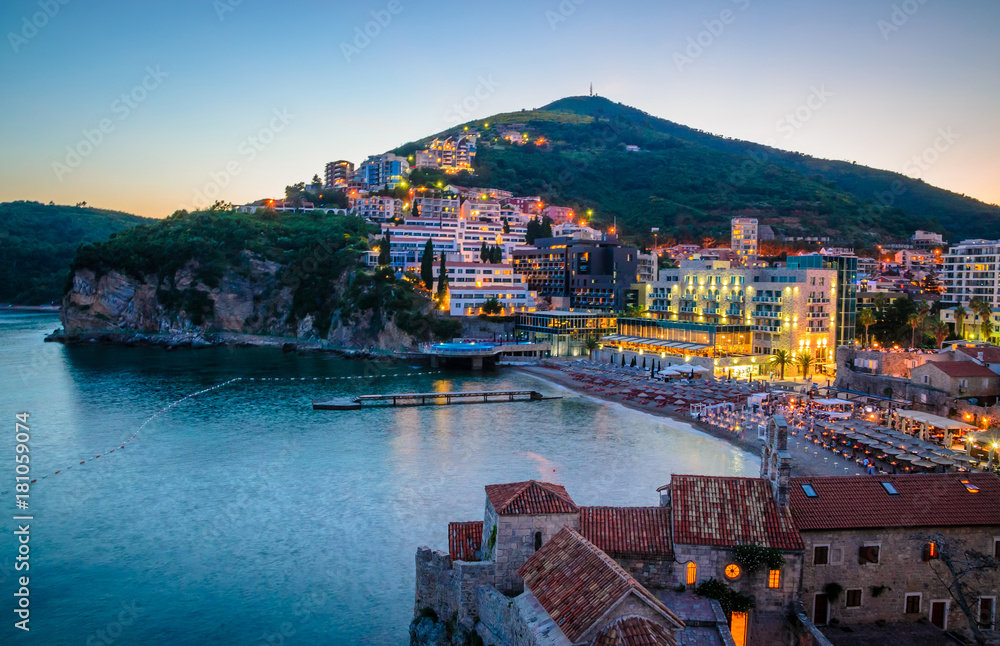 Aerial view on illuminated coastline and old town at night in Budva, Montenegro