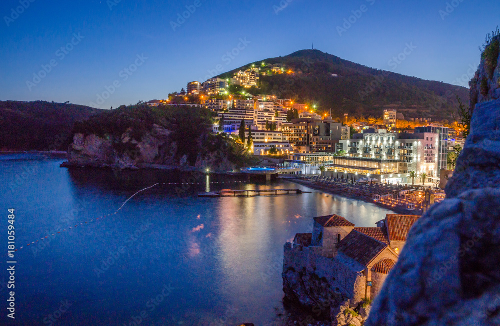 View on illuminated coastline and old town at night in Budva, Montenegro