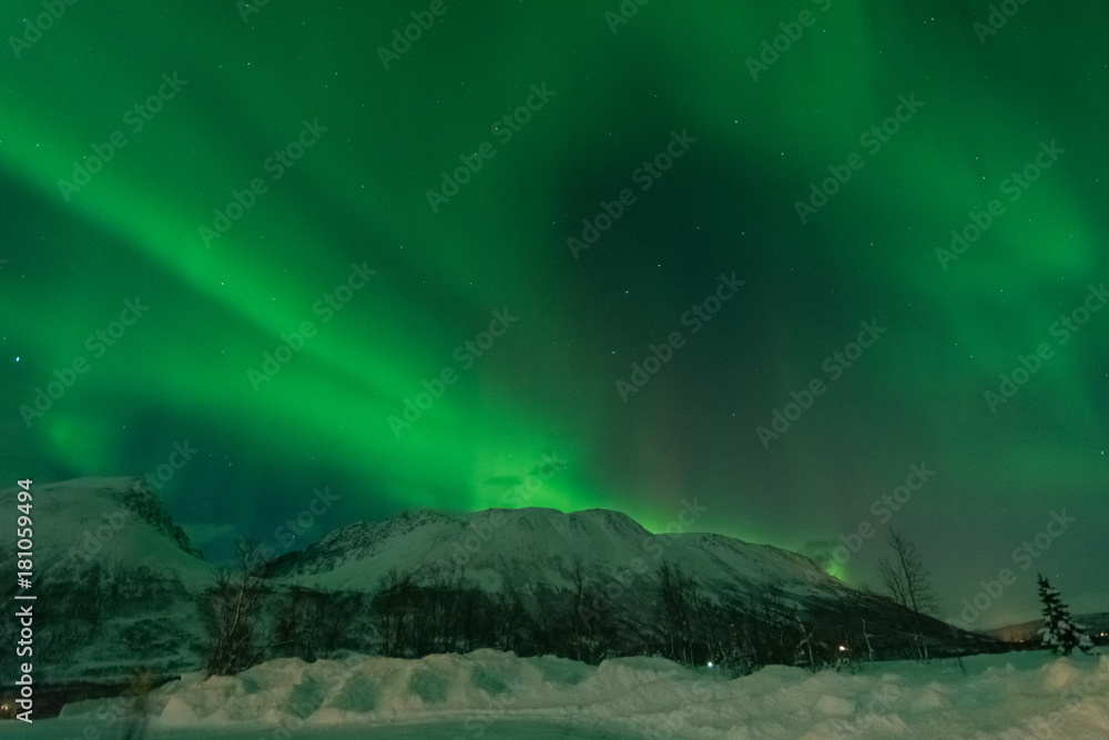 Northern lights over snowy mountain in winter ,Tromso,Norway