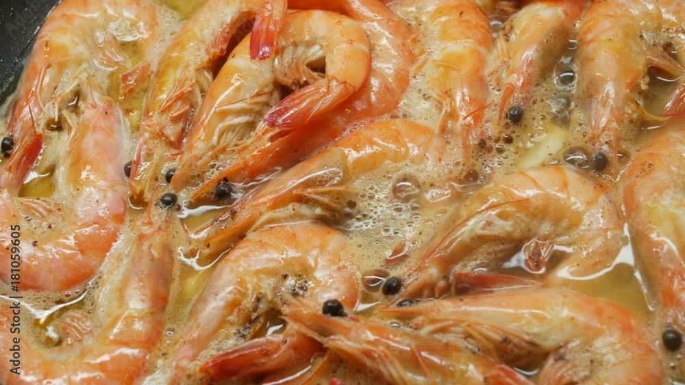 large red shrimps are fried in hot boiled oil on pan, close-up large red shrimps are fried in hot boiled oil on pan, close-up
